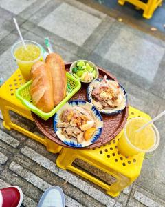 a picnic table with plates of food and drinks on it at Villas Checkin Hoa Giấy Gần Tháp Tam Thắng Bãi Sau in Vung Tau