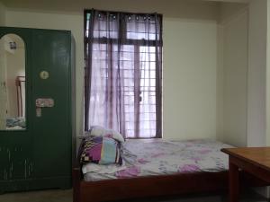 a bedroom with a bed in front of a window at Luhngam Homestay in Mon