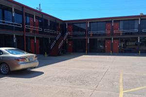 a car parked in a parking lot in front of a building at Coratel Inn and Suites By Jasper Anthony in Anthony