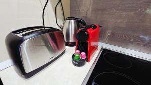 a kitchen counter with a microwave and a toaster at Lotti Apartman in Békéscsaba +10 photos