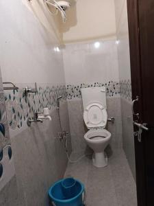 a bathroom with a toilet and a shower at Luhngam Homestay in Mon