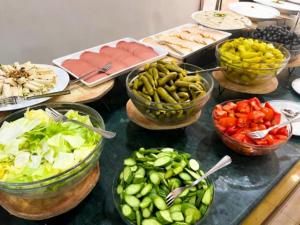 a table topped with bowls of vegetables and other foods at Olivia Rum Luxury Bubbles & Jeep Tours in Wadi Rum