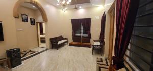 a living room with a chair and a window at Golden nest farm stay in Venkatāpur +4 photos