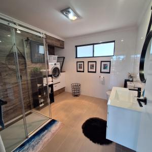 a bathroom with a shower and a sink at Relax Break - Bazza's Shack in White Beach +21 photos