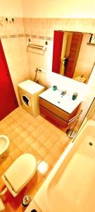 a bathroom with a sink and a toilet and a mirror at TT House Rho Fiera Milano Station in Rho +9 photos