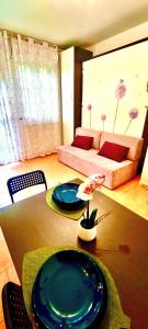 a living room with a table and a couch at TT House Rho Fiera Milano Station in Rho