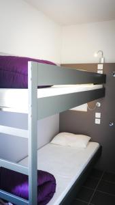 a couple of bunk beds in a room at Village Vacances passion La Buissière in Labeaume