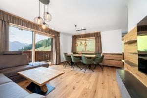a living room with a couch and a table at Das Grabnergut in Bad Hofgastein