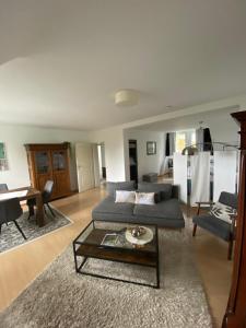a living room with a couch and a table at Kupfernest in Stolberg