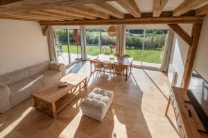 a living room with a couch and a table at Maison normande deauville in Bonneville-sur-Touques