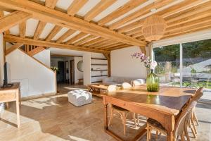 a living room with a wooden table and a couch at Maison normande deauville in Bonneville-sur-Touques