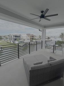 a living room with a couch and a ceiling fan at 141 Brand New Luxury 6BR 6BA Build with Heated Pool! home in Fort Myers Beach