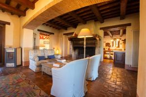a living room with a couch and a table at Casale Farnia in Montecastrilli