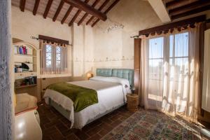 a bedroom with a bed and a large window at Casale Farnia in Montecastrilli +81 photos
