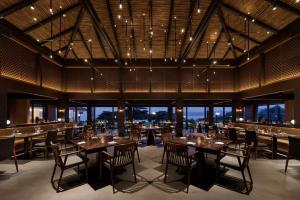 a dining room with tables and chairs and windows at Haimurubushi in Kohama +63 photos