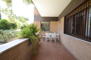 a patio with tables and chairs on a brick wall at Casa Di Silvana in Morena
