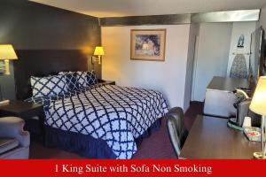 a hotel room with a king suite with solo non smoking at Coratel Inn & Suites by Jasper Hutchinson in Hutchinson