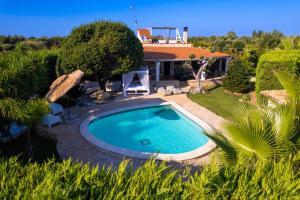 a swimming pool in a yard with a house at Villa Letto D'Alloro - Royal Dream in Conversano
