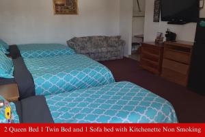 a hotel room with two beds and a couch at Coratel Inn & Suites by Jasper Hutchinson in Hutchinson +28 photos