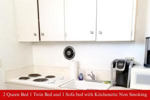 a kitchen counter with a stove and a microwave at Coratel Inn & Suites by Jasper Hutchinson in Hutchinson
