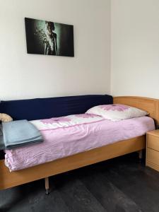 a bedroom with a bed with a purple blanket at Barrierefreie Ferienwohnung in Erkelenz