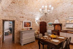 a kitchen with a table and a dining room at Villa Letto D'Alloro - Royal Dream in Conversano