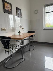 a dining room with a table and two chairs at Barrierefreie Ferienwohnung in Erkelenz +12 photos