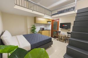 a bedroom with a bed and a kitchen and a staircase at Centana Hotel & Apartments in Ho Chi Minh City