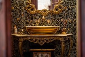 a bathroom with a gold sink and a mirror at Villa Letto D'Alloro - Royal Dream in Conversano +57 photos