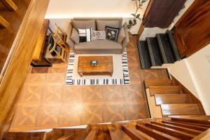 an overhead view of a living room with a couch and a table at Shanghai Hills & Well-time MCM Family B&B with Terrace Near Line2 Jing'an Temple in Shanghai +25 photos