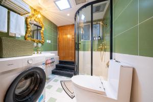 a bathroom with a washing machine and a shower at Shanghai Hills & Well-time MCM Family B&B with Terrace Near Line2 Jing'an Temple in Shanghai