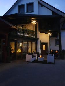 a house with white chairs in front of it at Mama's House in Cerklje na Gorenjskem