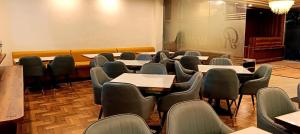 a room with rows of tables and chairs at Chocolate Inn, Patna in Patna