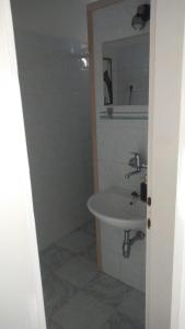 a bathroom with a sink and a mirror at Studio apartman Marija in Bol +18 photos