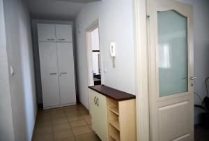 a room with a hallway with a cabinet and a mirror at Lihnidos Home, Central Apartment, AC, Lake Access, Beach in Ohrid +14 photos