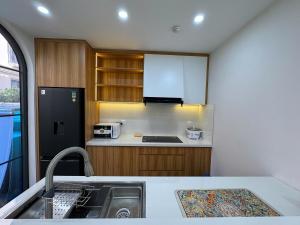 a kitchen with a sink and a refrigerator at Caca villa 3 bedrooms in Phu Quoc +21 photos