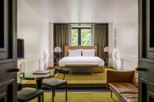 a hotel room with a bed and a couch at The Dean Munich, Autograph Collection in Munich +56 photos