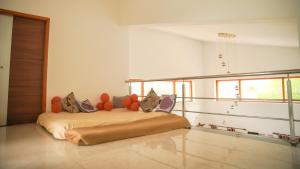 a bedroom with a bed with orange pillows on it at Willostays Cluster Clouds in Ooty
