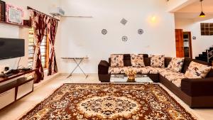 a living room with a couch and a rug at Willostays Cluster Clouds in Ooty