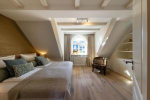 a bedroom with a large bed and a window at Haus Sylter Schönheit in Hörnum