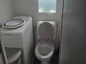 a small bathroom with a toilet and a window at Mobil home 3 chambres tout équipé avec accueil humain in Pont-Aven +18 photos