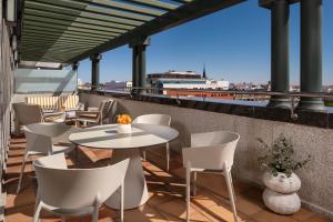 un patio con tavoli e sedie su un tetto di VP SOGNIO Metropolitano a Madrid