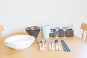 a table with forks and spoons and wine glasses at Rafore Building 26, Room 305 in Kumamoto +15 photos