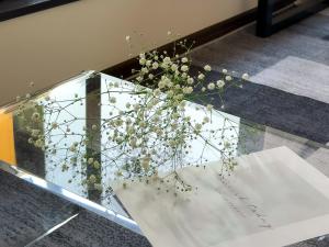 a vase of flowers sitting on a glass table at MANDO Hotel 101 in Tokyo