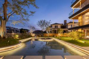 a swimming pool in the backyard of a house at Floral Luxury Jiuhua Mountain Above the Clouds B&B in Chizhou