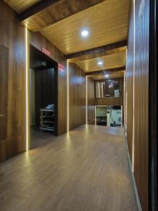 an empty room with wooden walls and wooden floors at City Stay Deluxe AC Dormitory in Madgaon