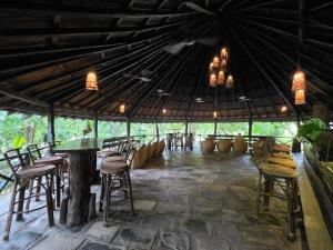 a room with chairs and a table in a tent at Siddhartha Wildlife Retreat in Meghauli