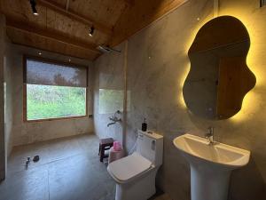 a bathroom with a sink and a toilet and a mirror at Samarth Krupa Beach Resort in Pālghar +23 photos