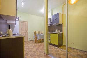 a kitchen with a counter and a table in a room at Apartment Next to Sennaya square in Saint Petersburg