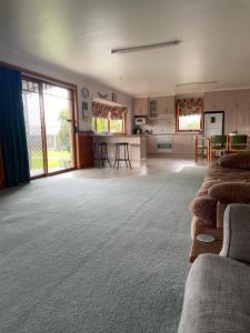 a large room with a kitchen and a living room at Our Cottage in Ross